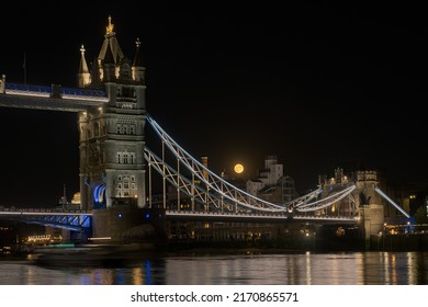 Full moon above the Tower Bridge in London with the pink full mon in the UK