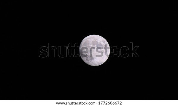 Full moon. The moon is an\
astronomical body full of metal against a dark universe\
background.