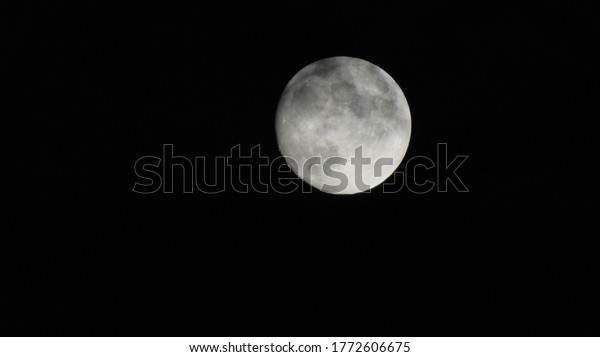 Full moon. The moon is an\
astronomical body full of metal against a dark universe\
background.