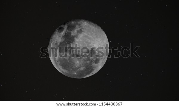 Full Moon background / The Moon is an astronomical\
body that orbits planet Earth and is Earth\'s only permanent natural\
satellite. It is the fifth-largest natural satellite in the Solar\
System