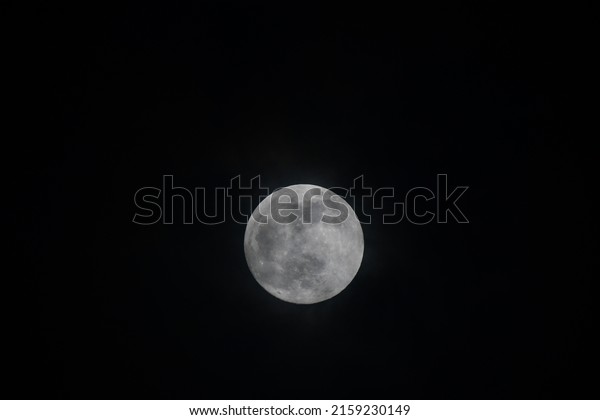 Full moon background in the midnight Thailand.moon\
and cloud nature background.Black night and full moon,Big lunar on\
the sky.