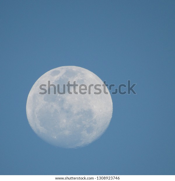 Full moon in a blue\
sky