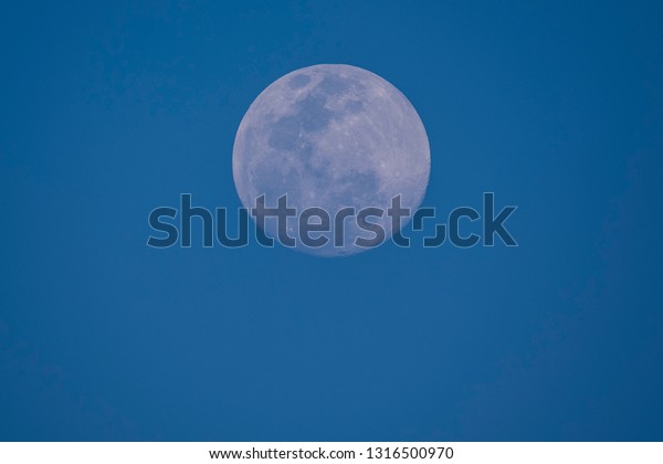 Full moon with blue\
sky