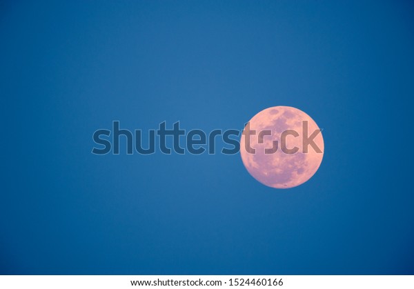 full moon in blue\
sky