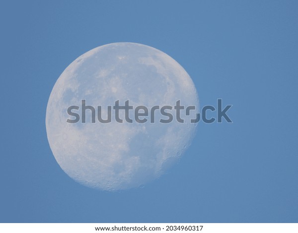full moon with blue sky\
background