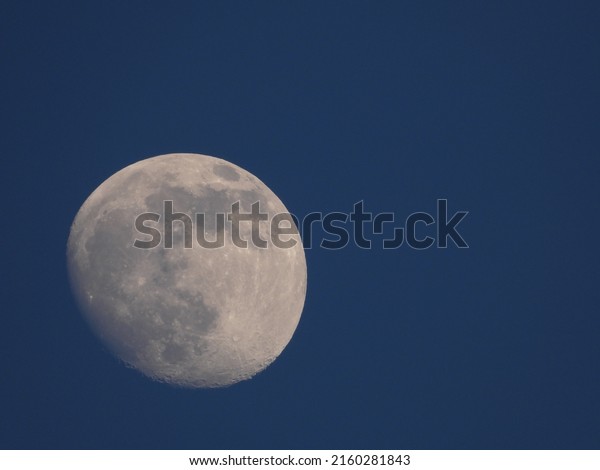 full moon with blue sky\
background