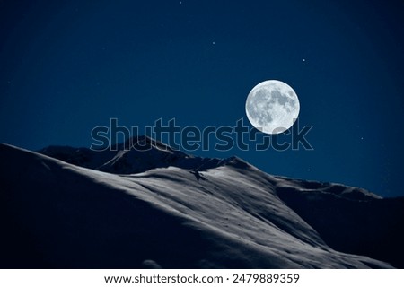 The Full moon casting it's glow onto the Talkeetna Mountains in Hatcher Pass Alaska