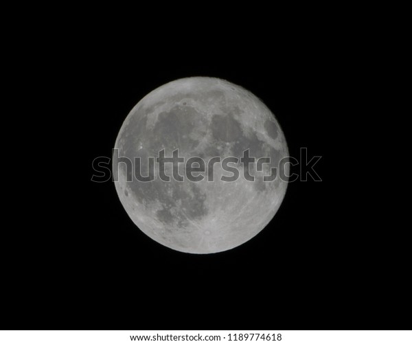 Full moon close up shot with dark or black\
background. It is the fifth largest satellite in the solar system\
with an average distance of 384,403 kilometers from the center to\
the center to center.