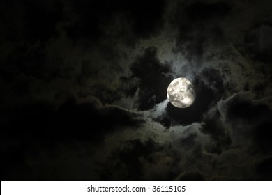 Full Moon Close-up And Eerie White Clouds Against A Black Night Sky