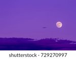 The full moon and the clouds as background.