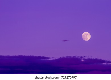 The full moon and the clouds as background.