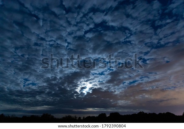 Full moon in\
the clouds. The concept of\
mystery.