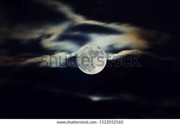 full moon with\
clouds looking like a wolf