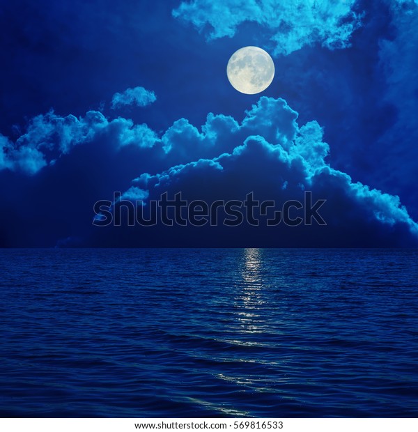 full moon in clouds over\
sea