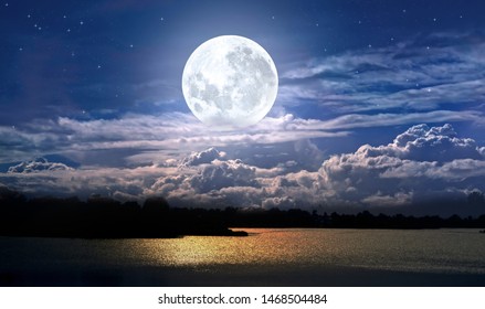 Full Moon And Cloudy Sky Over The Night Lake