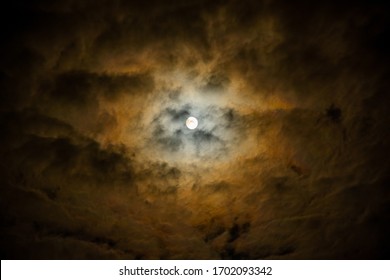 Full Moon In Cloudy Sky Over Paris, France Leads To False Human Face Perception (pareidolia).