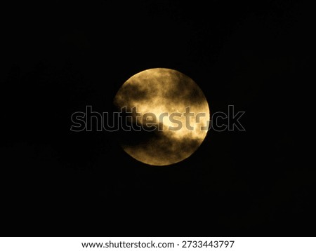 The full moon covered with Moving clouds at dawn
