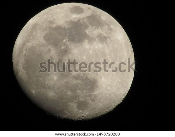 Full Moon with dark black background, moon\
surface, spot on moon surface.\
