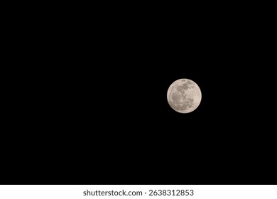 Full moon in dark night sky wih negative space. Perfectly round. Clear lunar surface with visible craters. Astronomy, space, celestial body, night sky background, moonlight, astrophotography. Blur
