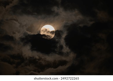 full moon with dark thick clouds