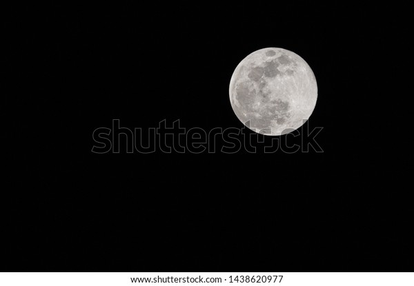Full moon in details on\
black sky