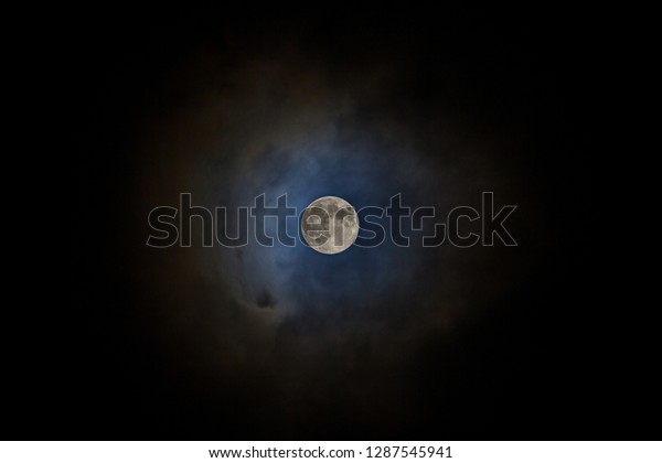 Full moon with fog and\
cloudy. The moon were not furnished. Night sky and a full moon in\
the clouds.