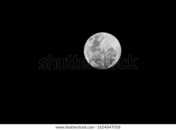 Full moon in great detail with the all black back\
of the dark night