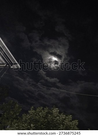 Full moon hidden by clouds