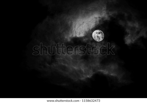 Full moon in the middle of\
clouds