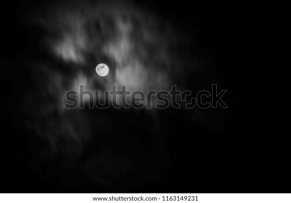 Full moon in the middle of\
clouds