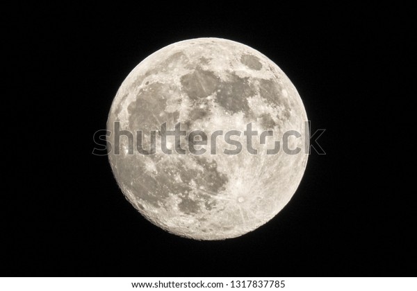 full moon in natural color aerial night detail view\
from planet earth isolated on black sky background astronomy deep\
space landscape scene
