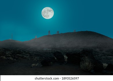 The Full Moon At Night Over The Observatory For Stargazing On The Spanish Atlantic Island Of Tenerife. The Scenery At High Altitude In The Volcanic Area Is In The Haze.