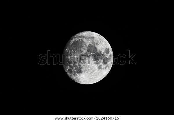 Full moon  on black\
background. Close up Image. Bright lunar satellite.\
Moon  in\
darkness.