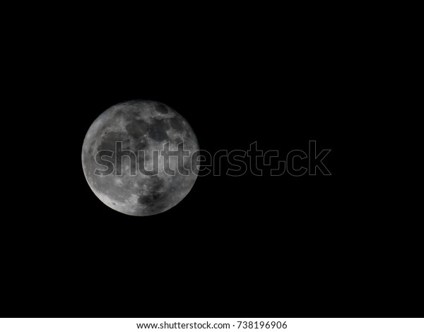 Full moon\
on black background. It is a black and white image that see details\
on the surface. Look again is awesome suitable for Halloween\
background. Moon orbit planet\
Earth.