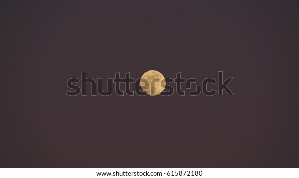 Full moon on a cloudy night\
sky