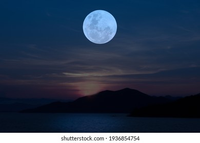 Full Moon On Sky Over Lake In The Evening.