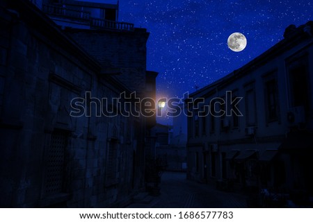 Full moon over the city at night, Baku Azerbaijan. Big full moon shining bright over buildings