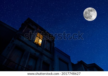 Full moon over the city at night, Istanbul, Turkey. Big full moon shining bright over buildings. Night cityscape
