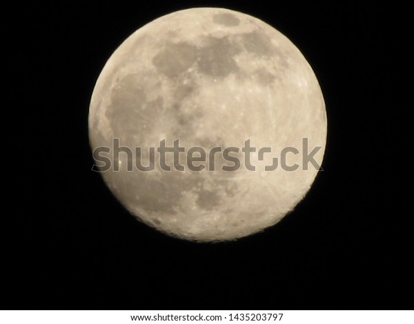 Full moon over Iloilo City on dark skies                \
              