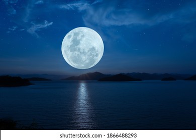 Full Moon Over Lake In The Dark Night.