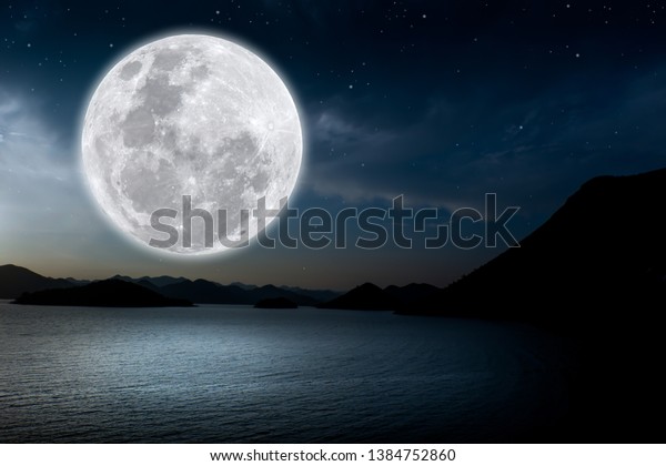Full moon over lake in\
the dark night.