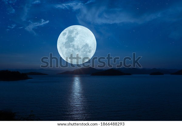 Full moon over lake in\
the dark night.
