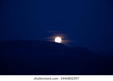 Full moon over the mountain range at night. Full moon photos in dark night.
