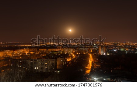 
full moon over night city