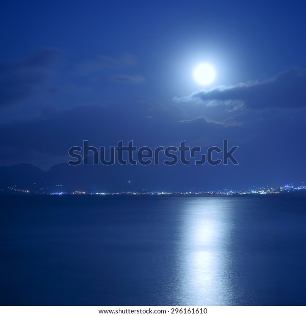 Full\
moon over sea and moon-glade, Crete Island,\
Greece