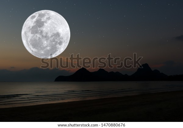 Full moon over sea at\
night.