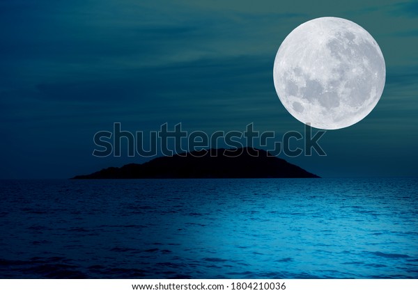 Full moon over sea in the\
night.