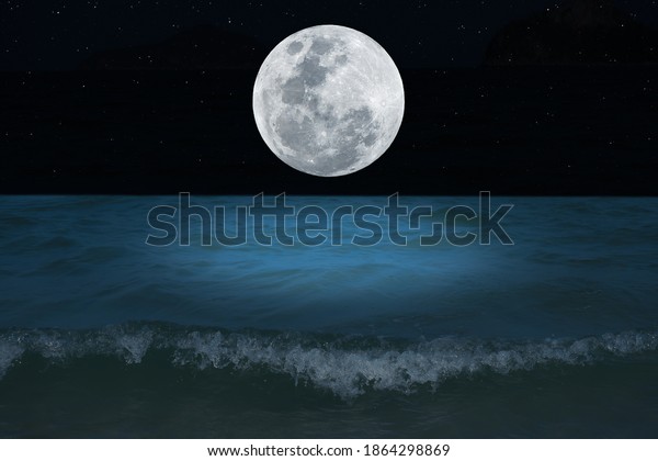 Full moon over the sea at\
night.