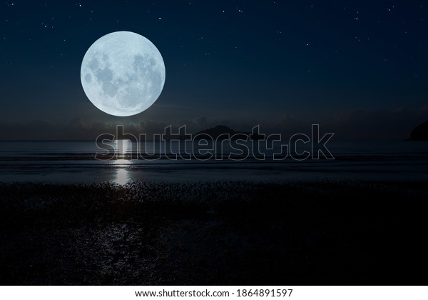 Full moon over the sea at\
night.