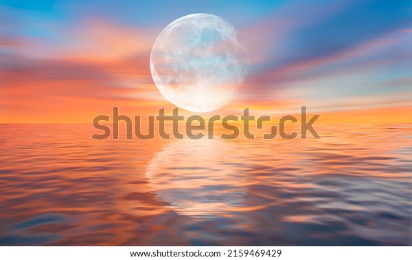 Full moon over the sea at sunset \